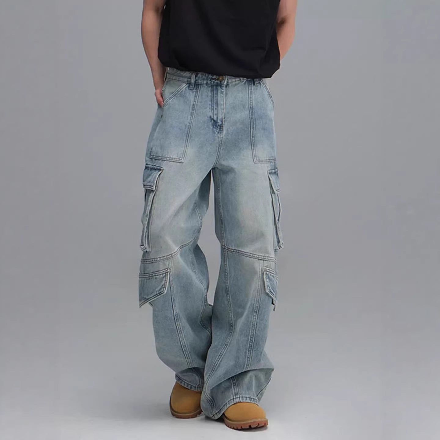 Men’s washed blue denim workwear jeans with a relaxed wide-leg fit, mid-rise waist, button fly and multiple utility pockets.