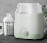 Portable USB baby bottle warmer with a 2000 mAh rechargeable battery, available in green and pink for gradual milk warming and heat preservation.
