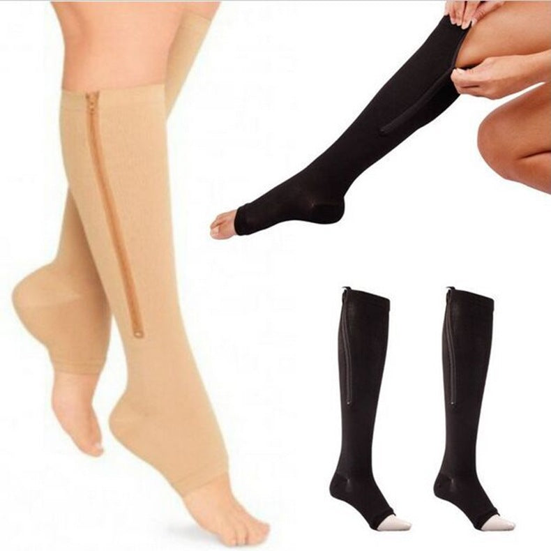 Women’s knee-high nylon and spandex calf-support socks with an open toe and side zipper, available in black, powder grey and skin colour.