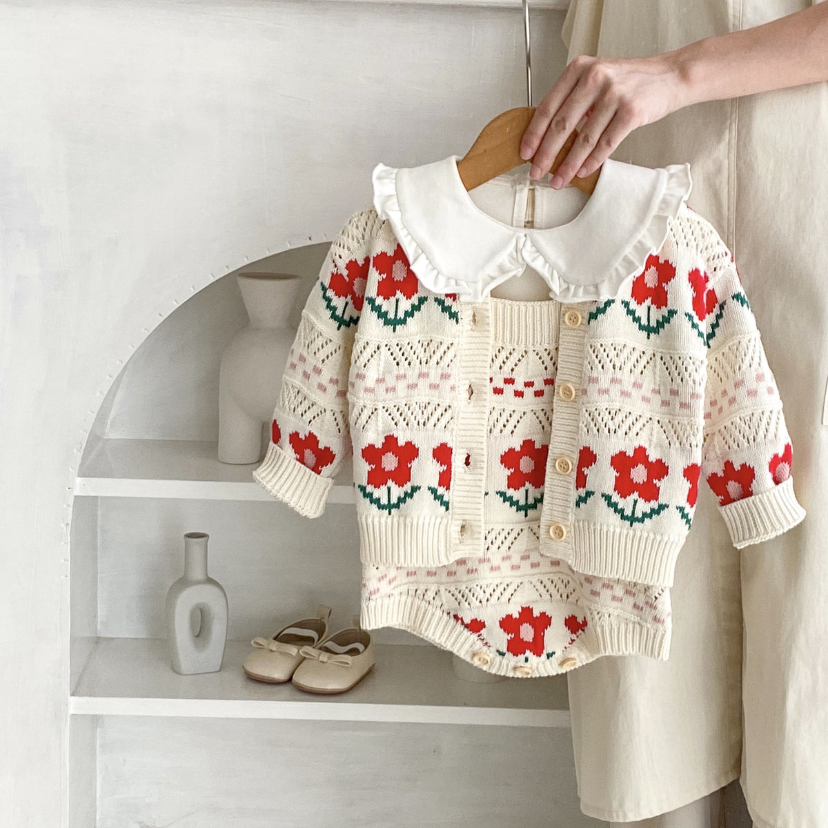 Apricot-white cotton cardigan or romper for baby girls with long sleeves and a single-breasted fastening.