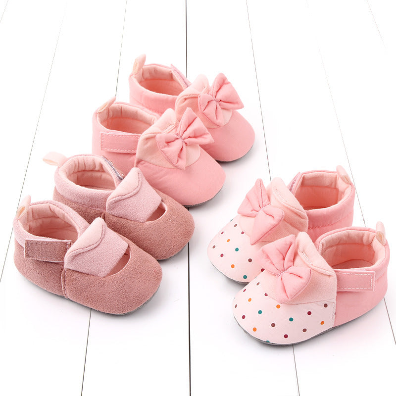 Cotton bow baby and toddler shoes with Velcro fastening, available in pink and polka-dot designs and sizes from 11 to 13 cm.