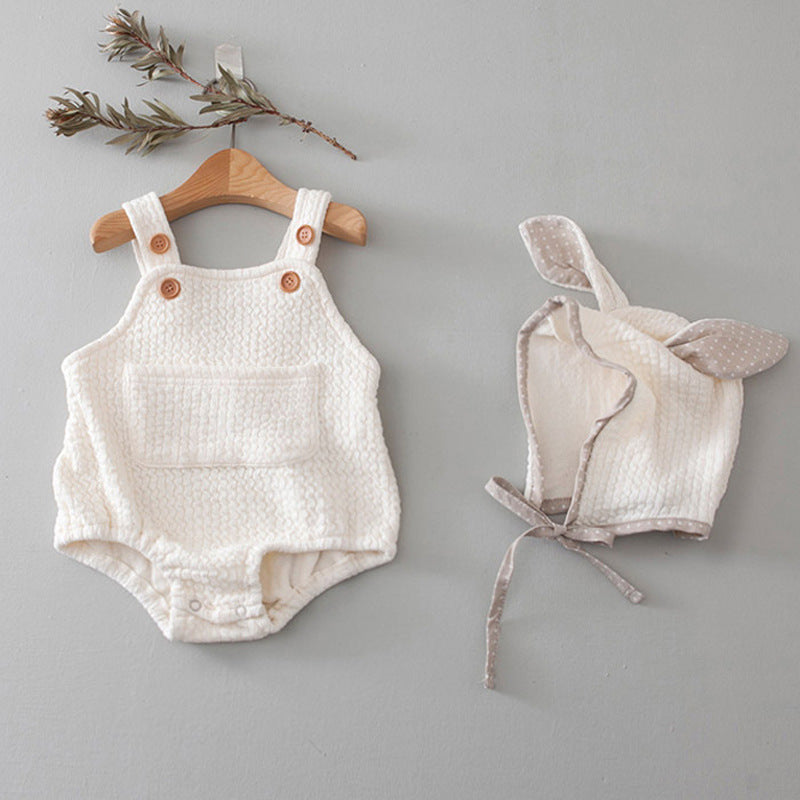 Cotton newborn triangle-style jumpsuit with a matching hat, available in pink and a light neutral colour.