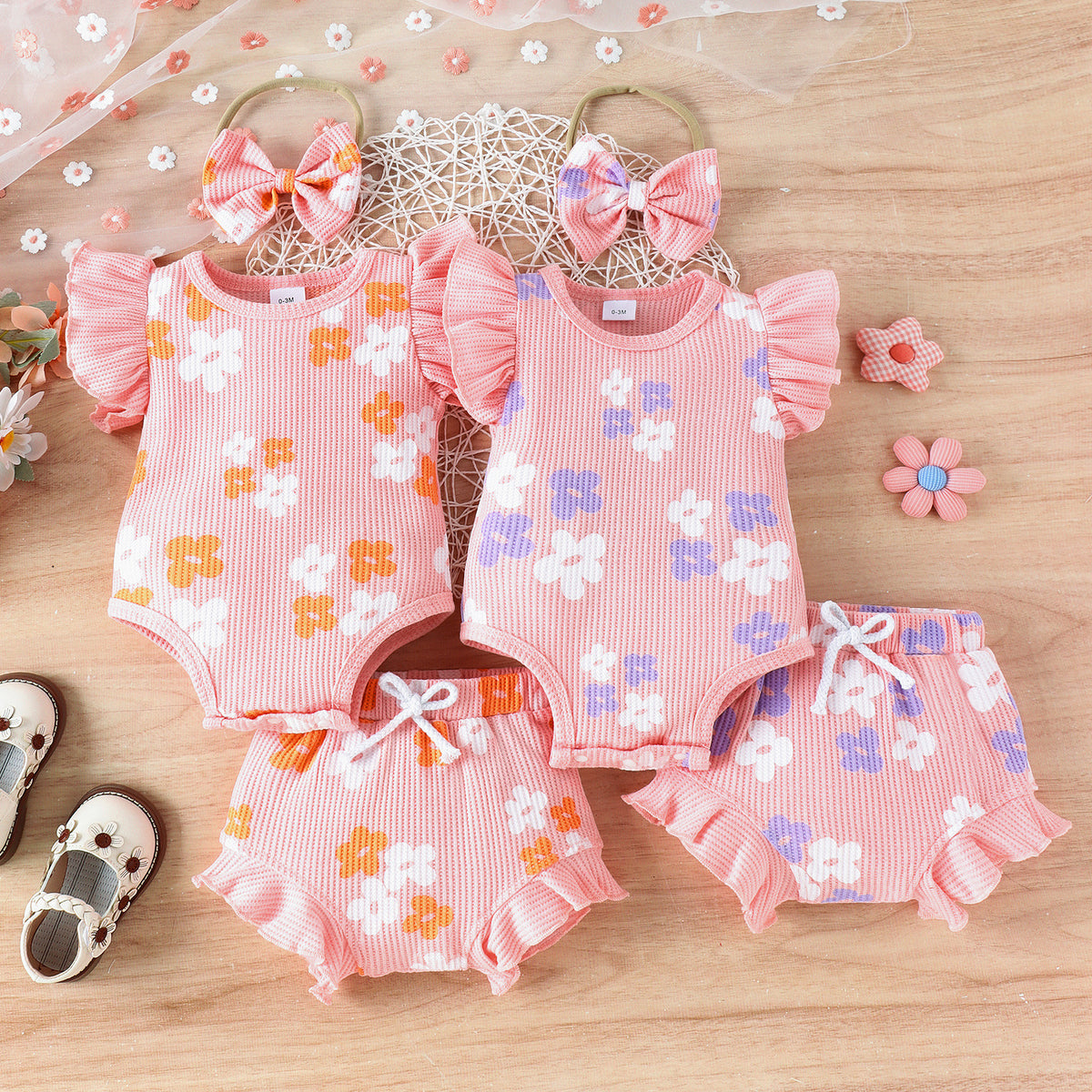 Floral cotton baby girl set with a sleeveless bodysuit and matching shorts, available in purple or yellow.