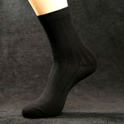 Black men’s mid-calf combed cotton dress sock with a subtle ribbed upper and solid-colour design