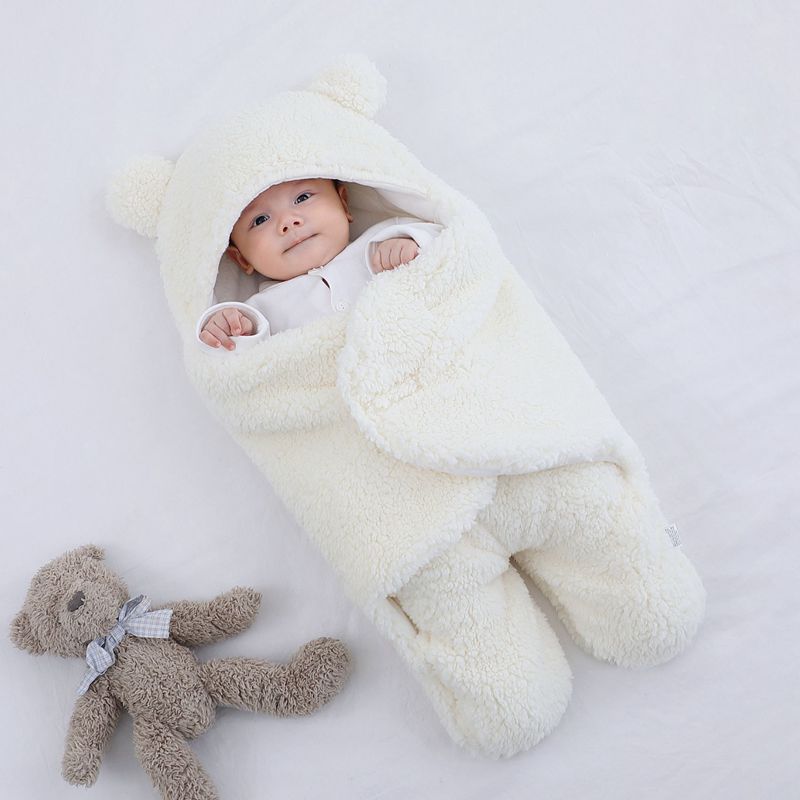 Quilted cotton-blend baby wrap sleeping bag with soft filling, available in six colours and three sizes.