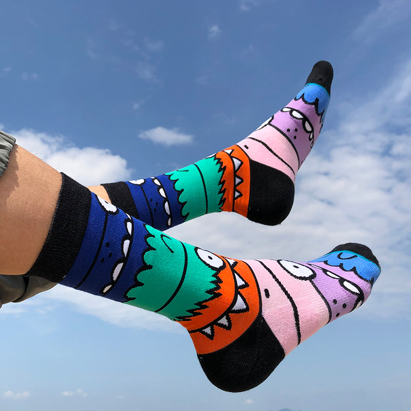 Unisex high-tube cotton socks with a colourful cartoon character pattern in blue, green, orange, pink and black