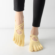 Women wearing yellow five-toe ballet yoga socks with elastic cross straps and a low-cut combed cotton design