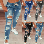 Women’s high-waisted ripped harem jeans with an elastic drawstring waistband, loose full-length fit and distressed detailing