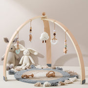 Natural wooden baby activity gym with plush, crochet and beech-bead hanging toys for supervised floor play.